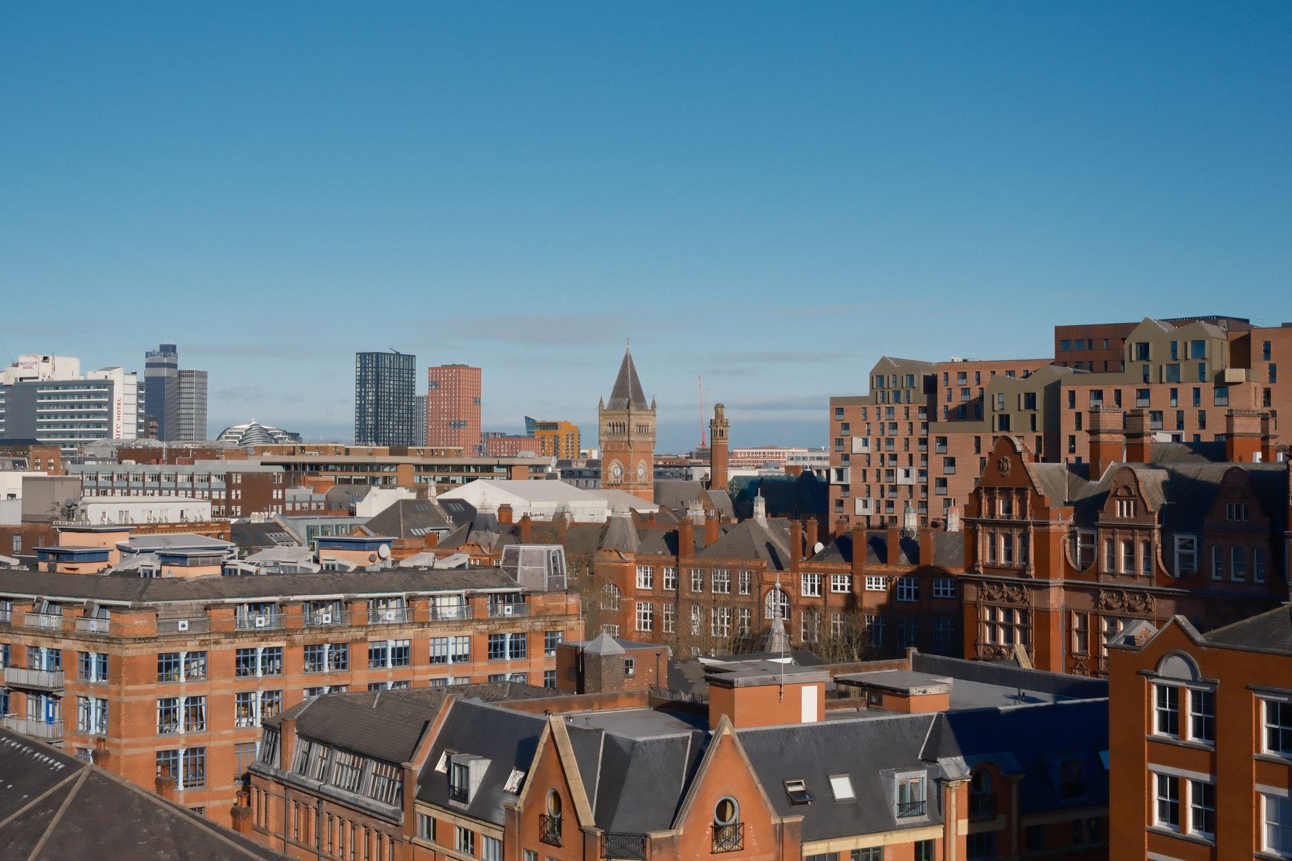 City rooftops under a clear blue sky
